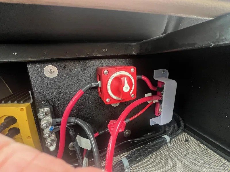 Slide: The Image of Electrical system of a 2022 Harris Cruiser 230 boat, featuring red cables and a power switch. - 23