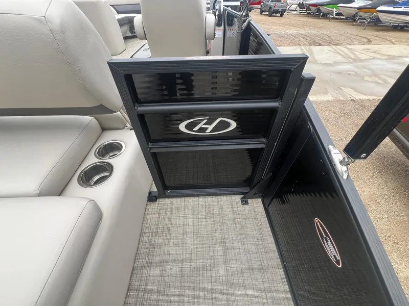 Slide: The Image of 2022 Harris Cruiser 230 interior with seating, cup holders, and branded gate. - 26