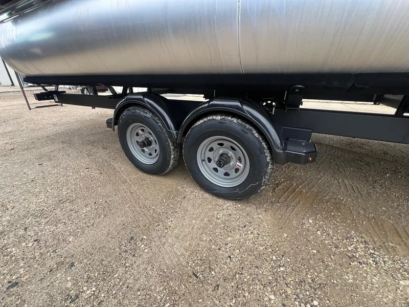 Slide: The Image of Trailer wheels of a 2022 Harris Cruiser 230 on gravel surface. - 27
