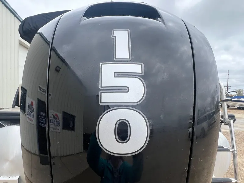 Slide: The Image of Close-up of a 2022 Harris Cruiser 230 boat engine with "150" marking. - 7