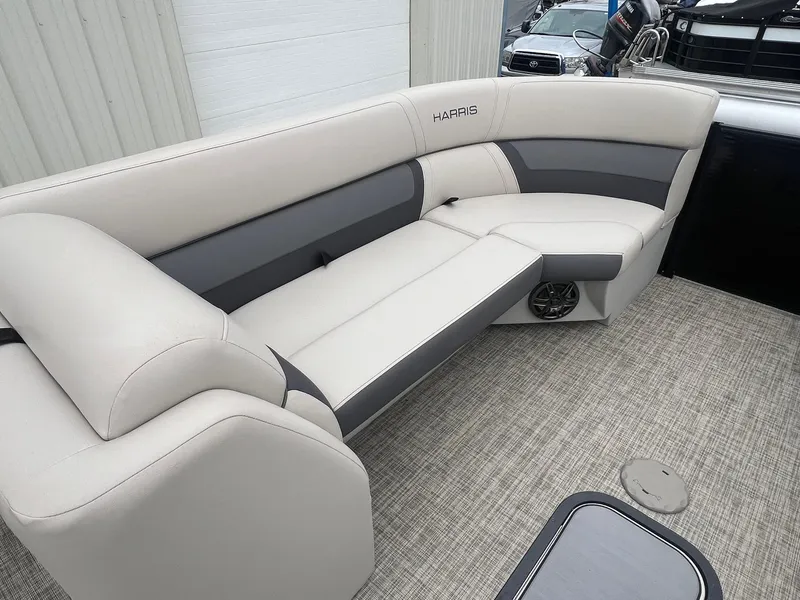 Slide: The Image of 2022 Harris Cruiser 230 boat interior with beige and gray seating. - 9