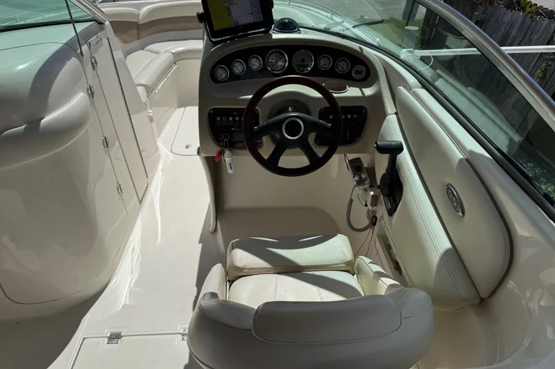 Slide: The Image of 2004 Chaparral 260 SSi boat interior with steering wheel and dashboard controls. - 10