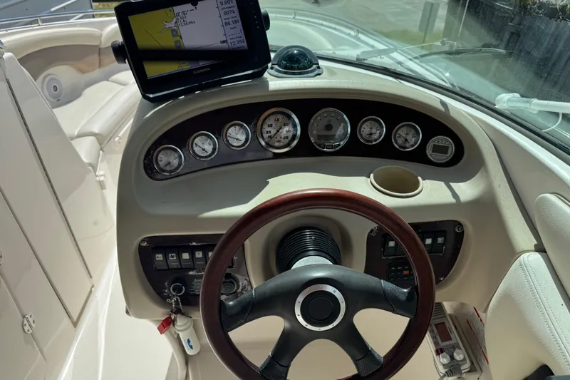Slide: The Image of Dashboard of a 2004 Chaparral 260 SSi boat with steering wheel and navigation system. - 11