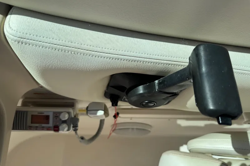 Slide: The Image of Interior of 2004 Chaparral 260 SSi boat showing control panel and handle. - 14