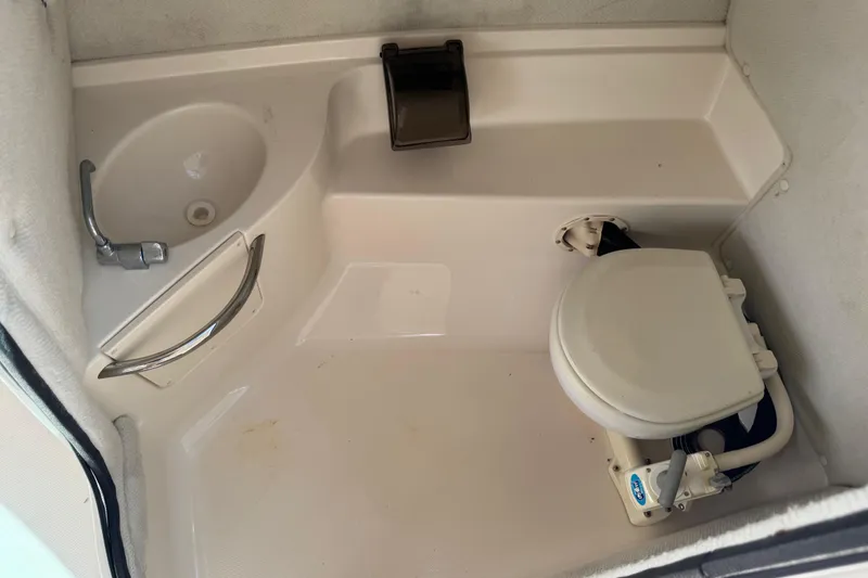 Slide: The Image of 2004 Chaparral 260 SSi boat bathroom with sink and toilet. - 18
