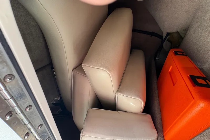 Slide: The Image of Interior of 2004 Chaparral 260 SSi boat with beige cushions and orange case. - 20