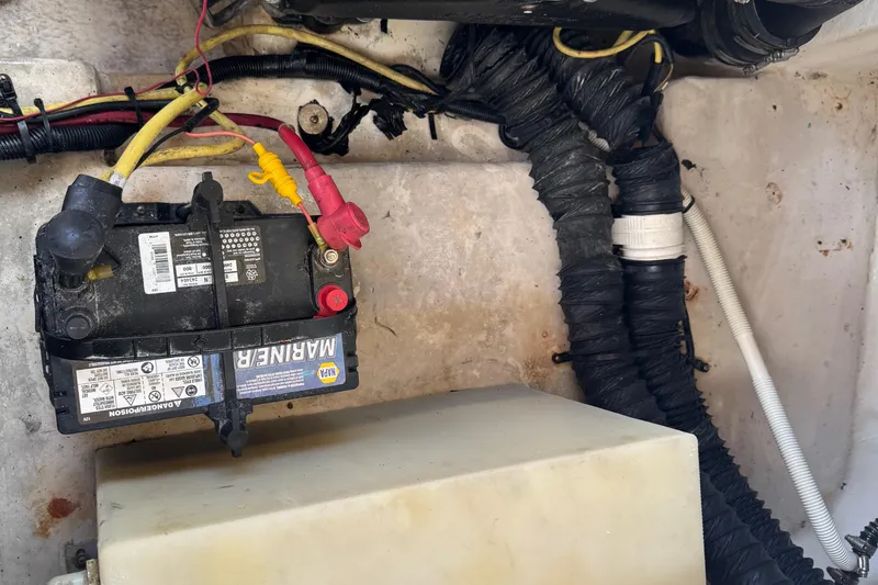 Slide: The Image of 2004 Chaparral 260 SSi boat battery compartment with wiring and marine battery. - 5