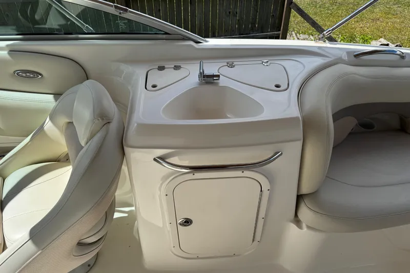 Slide: The Image of 2004 Chaparral 260 SSi boat interior with sink and seating area. - 9