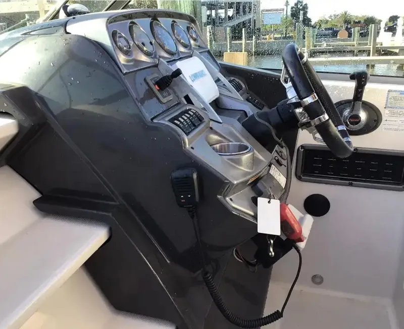 Slide: The Image of Helm of 2013 Monterey 260 SCR boat with steering wheel and control panel. - 16