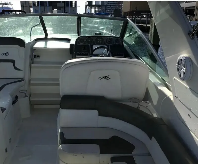 Slide: The Image of 2013 Monterey 260 SCR boat interior with helm, seating, and dashboard. - 17