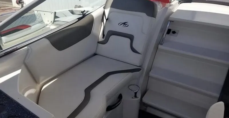 Slide: The Image of 2013 Monterey 260 SCR boat interior with white and gray seating. - 18