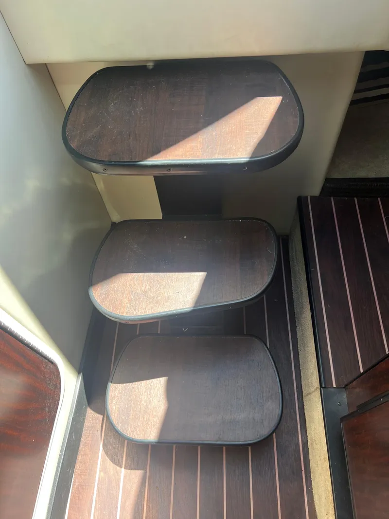 Slide: The Image of Steps inside a 2013 Monterey 260 SCR boat, featuring dark wood finish. - 20