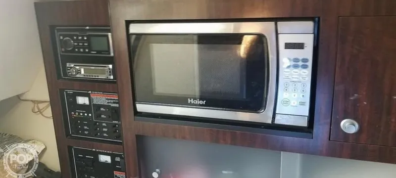 Slide: The Image of 2013 Monterey 260 SCR interior with Haier microwave and control panels. - 21