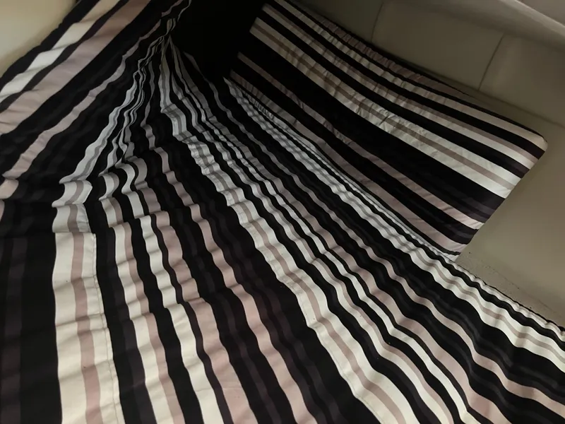 Slide: The Image of Striped bedding in a 2013 Monterey 260 SCR cabin interior. - 26