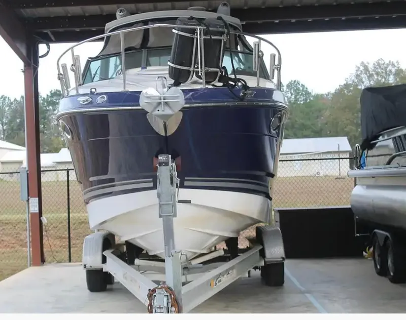 Slide: The Image of 2013 Monterey 260 SCR boat on trailer in covered storage area. - 3