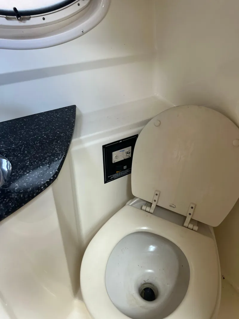 Slide: The Image of 2013 Monterey 260 SCR boat bathroom with toilet and countertop. - 30