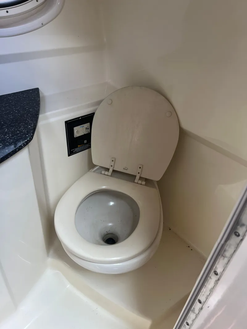 Slide: The Image of 2013 Monterey 260 SCR boat bathroom with toilet and countertop. - 31