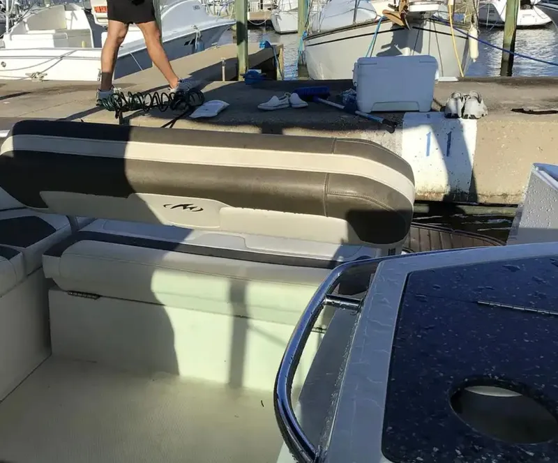 Slide: The Image of 2013 Monterey 260 SCR boat docked, featuring seating area and marina view. - 32