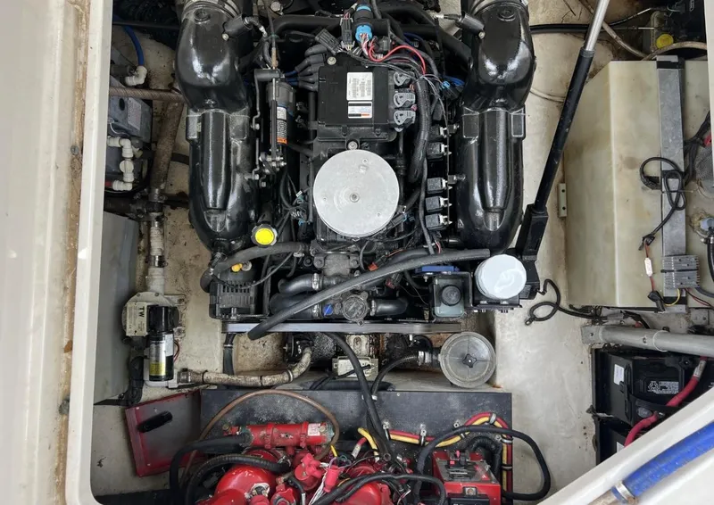 Slide: The Image of Engine compartment of a 2013 Monterey 260 SCR boat, showcasing mechanical components and wiring. - 34