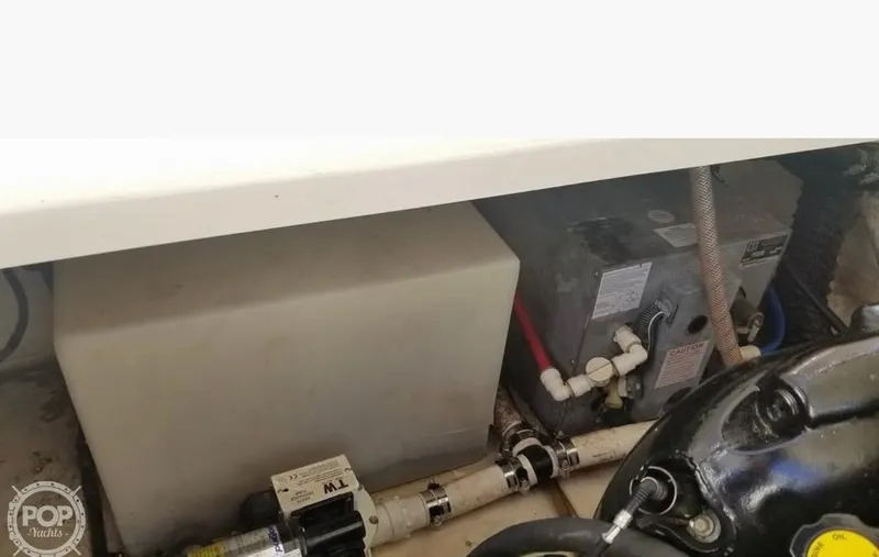 Slide: The Image of Engine compartment of a 2013 Monterey 260 SCR boat, showing mechanical components and piping. - 35