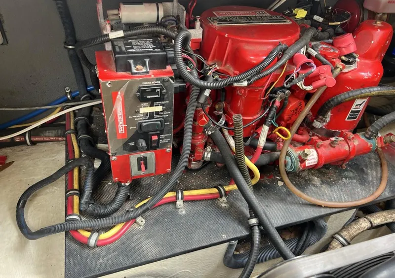 Slide: The Image of Engine compartment of a 2013 Monterey 260 SCR boat with red components and wiring. - 37