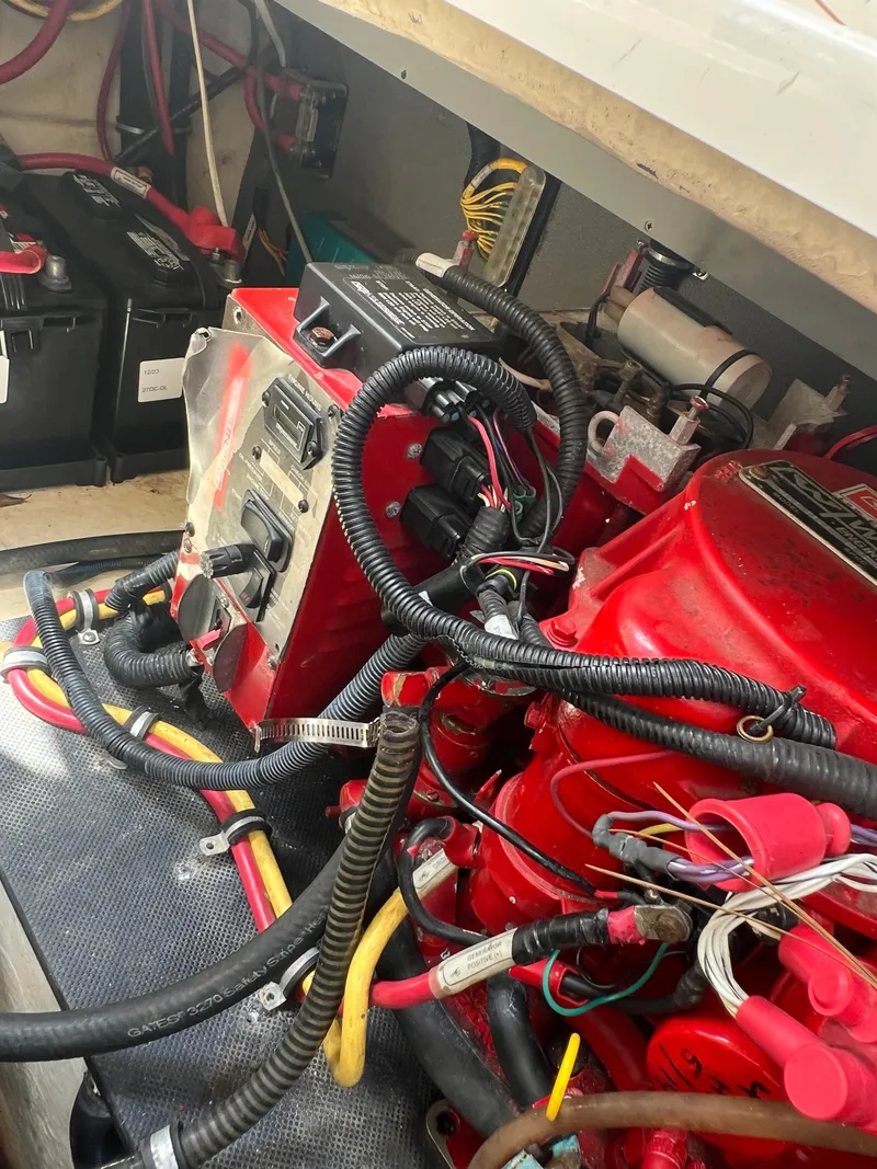 Slide: The Image of Engine compartment of a 2013 Monterey 260 SCR boat with visible wiring and components. - 38