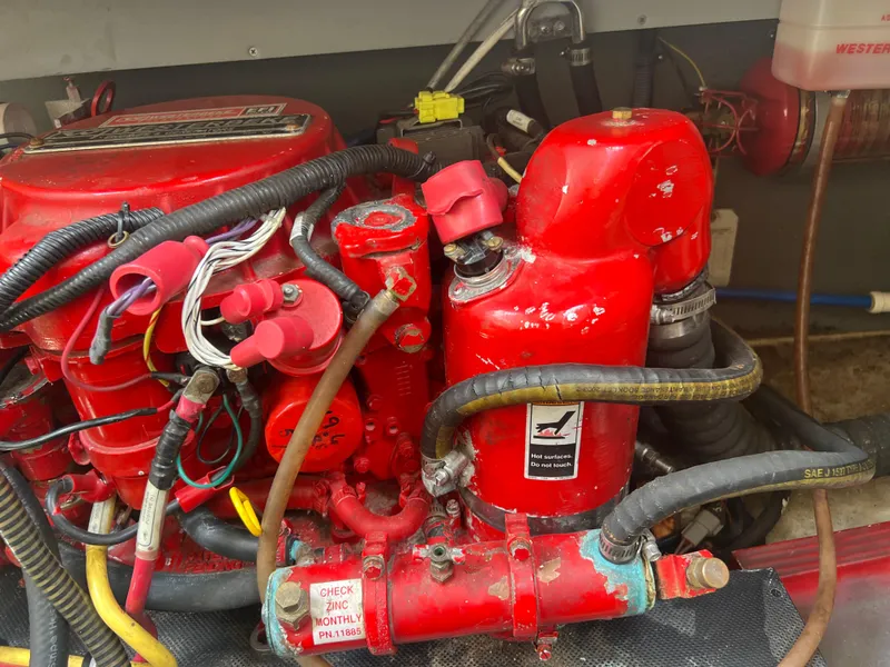 Slide: The Image of Engine compartment of a 2013 Monterey 260 SCR boat with red components and wiring. - 39