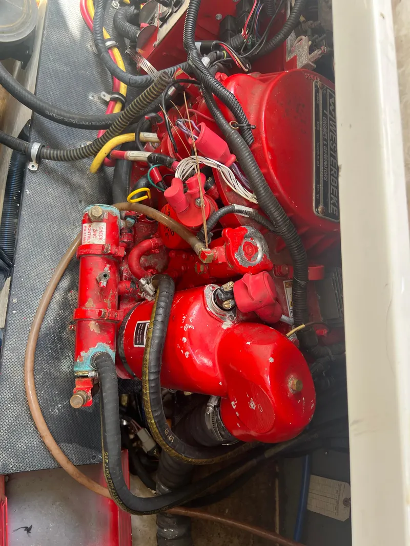 Slide: The Image of Engine compartment of a 2013 Monterey 260 SCR boat, featuring red components and wiring. - 41
