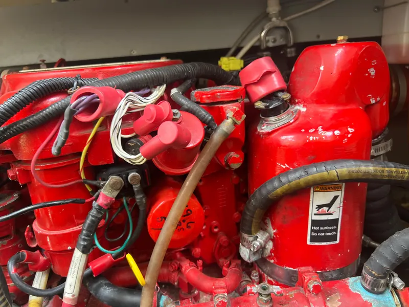 Slide: The Image of Engine components of a 2013 Monterey 260 SCR boat, featuring red wiring and connectors. - 42