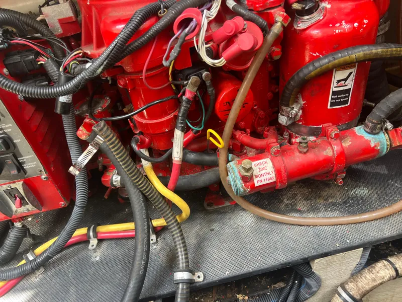 Slide: The Image of Engine components of a 2013 Monterey 260 SCR boat, featuring red wiring and hoses. - 45