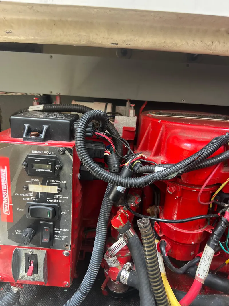 Slide: The Image of Engine compartment of a 2013 Monterey 260 SCR boat, featuring red components and wiring. - 46