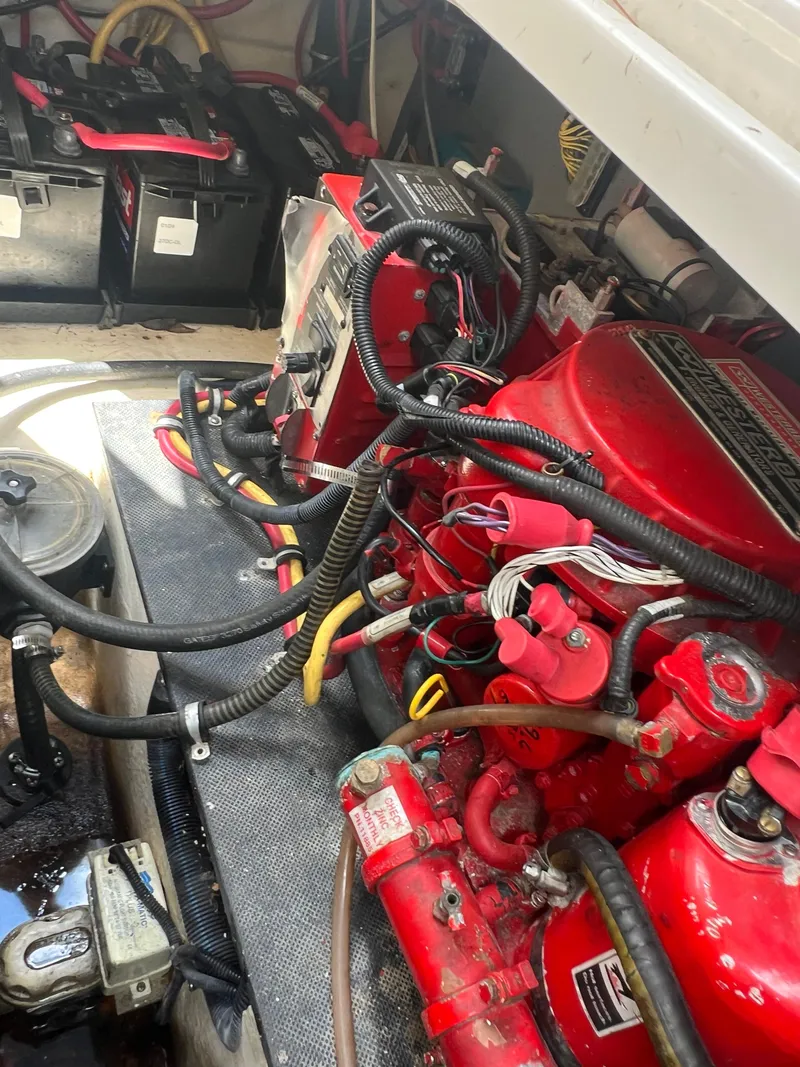 Slide: The Image of Engine compartment of a 2013 Monterey 260 SCR boat, featuring red engine components. - 47