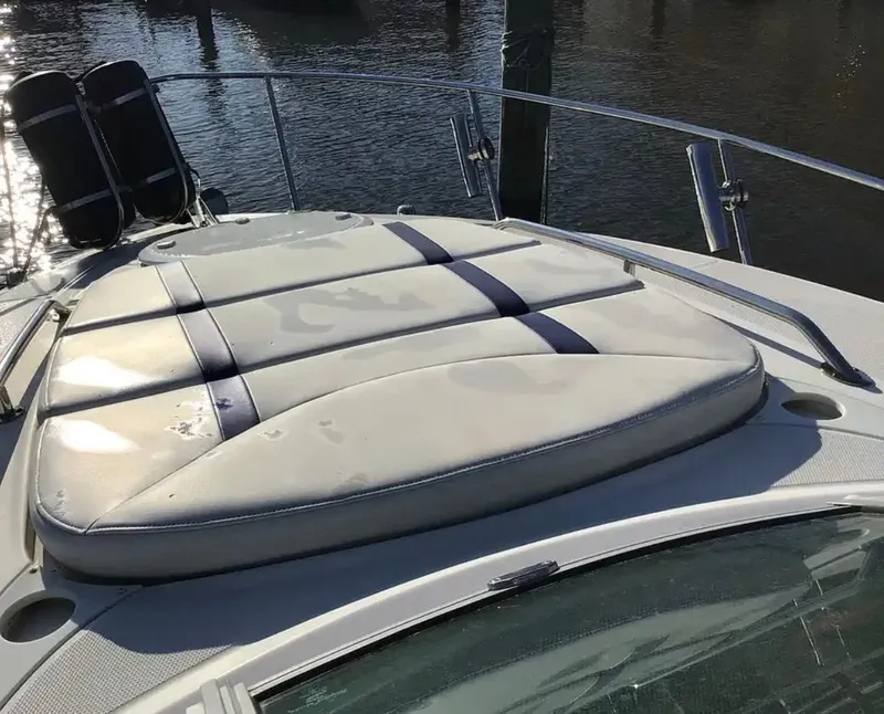 Slide: The Image of 2013 Monterey 260 SCR boat with cushioned sun deck, docked by the water. - 8