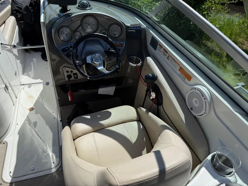 Slide: The Image of 2015 Rinker 246 Bowrider boat cockpit with steering wheel and gauges. - 6