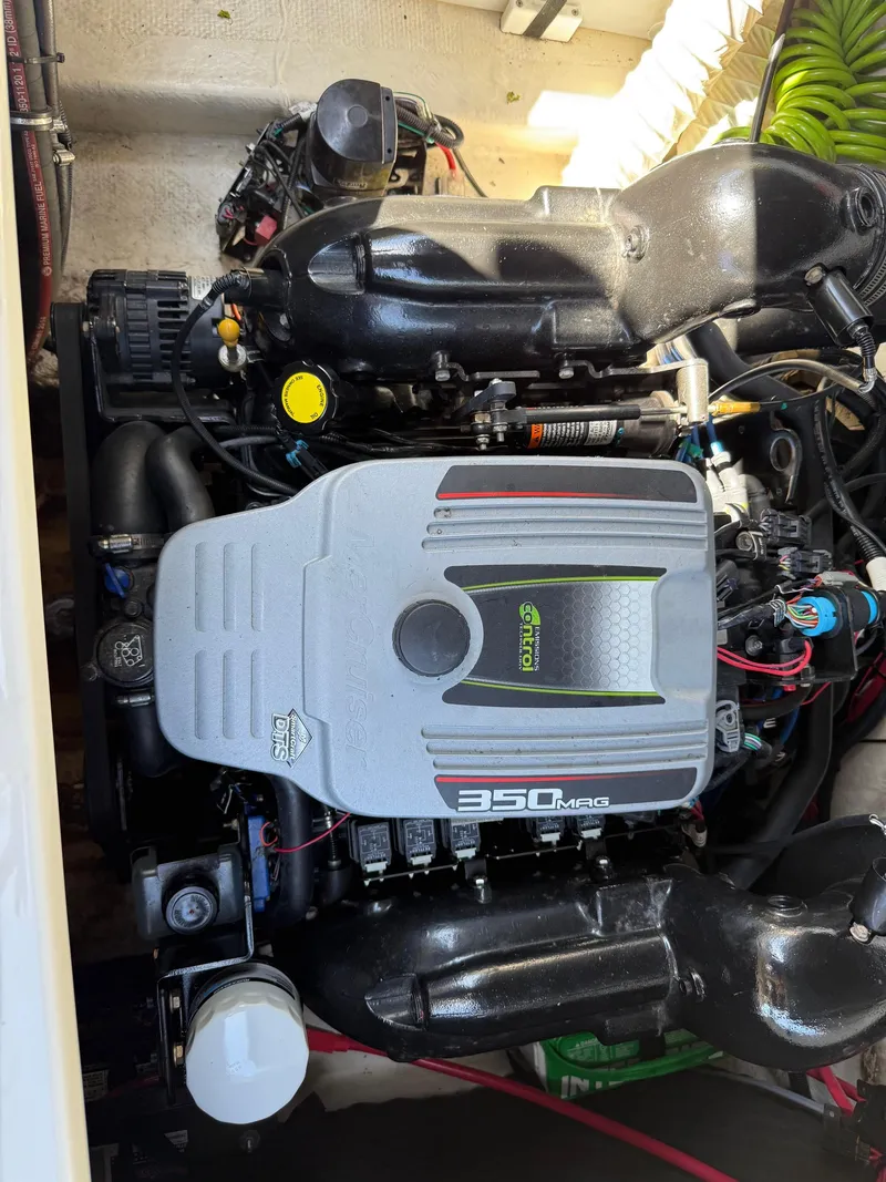 Slide: The Image of Engine of a 2015 Rinker 246 Bowrider boat, featuring a 350 MAG motor. - 8