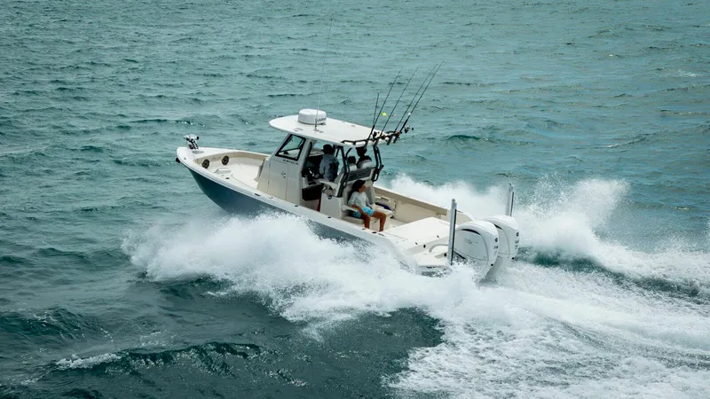 Slide: The Image of 2025 Solace 28 HCS boat navigating choppy waters, equipped for fishing. - 1