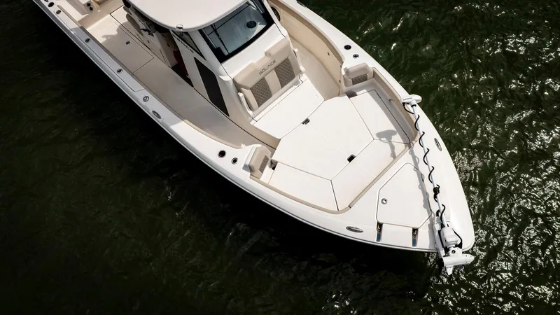 Slide: The Image of 2025 Solace 28 HCS boat on water, aerial view, sleek design. - 2