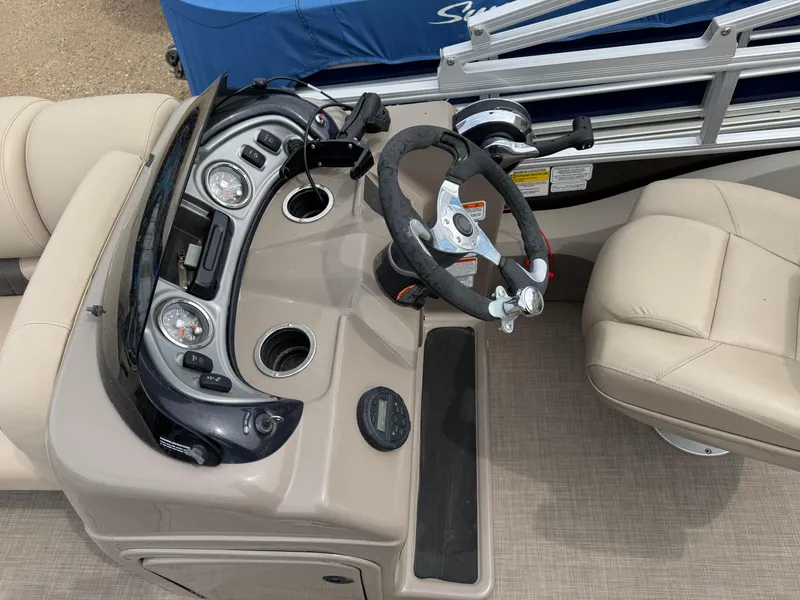 Slide: The Image of 2020 Sun Tracker Fishin' Barge 24 XP3 dashboard with steering wheel and gauges. - 14