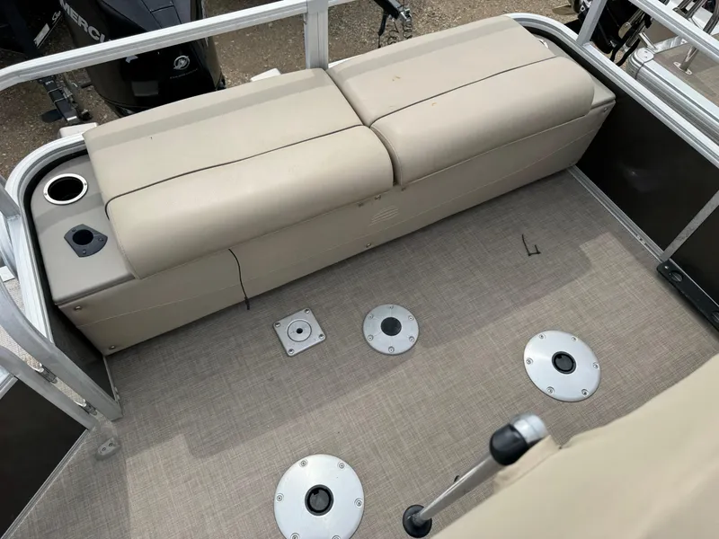 Slide: The Image of 2020 Sun Tracker Fishin' Barge 24 XP3 interior with beige seating and fishing rod holders. - 16