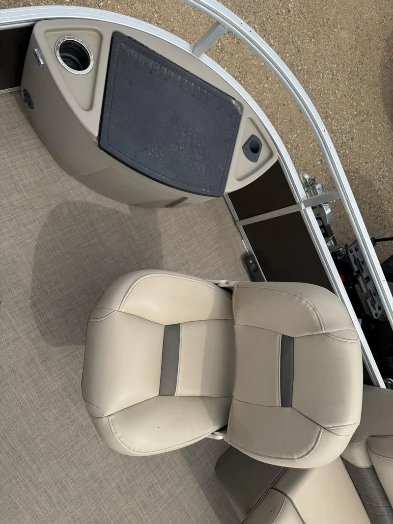 Slide: The Image of 2020 Sun Tracker Fishin' Barge 24 XP3 boat interior with beige seating and fishing station. - 6