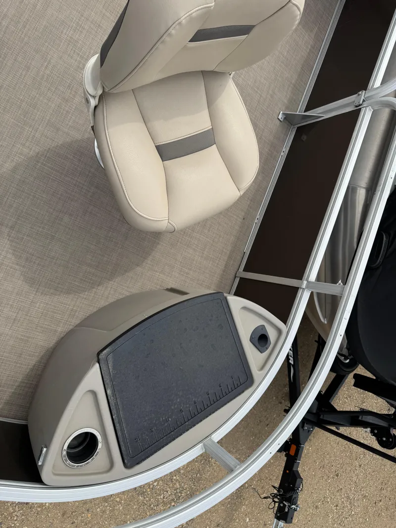Slide: The Image of 2020 Sun Tracker Fishin' Barge 24 XP3 interior with beige seating and fishing station. - 7