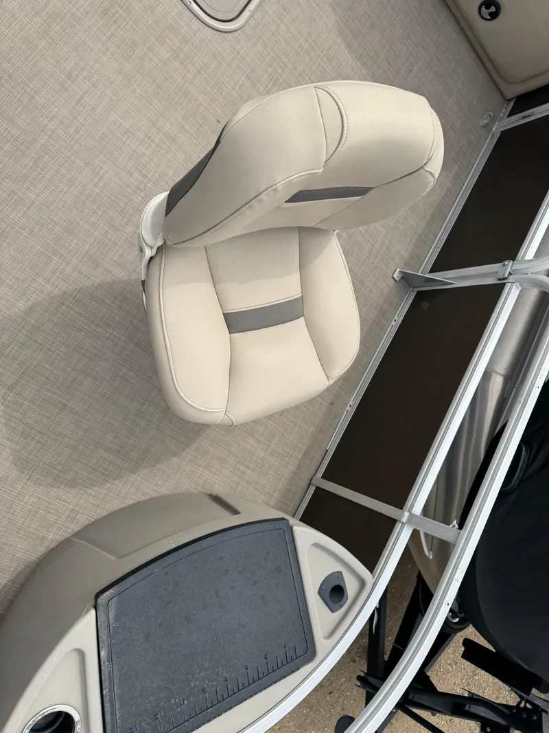 Slide: The Image of 2020 Sun Tracker Fishin' Barge 24 XP3 interior with beige seating and console. - 8