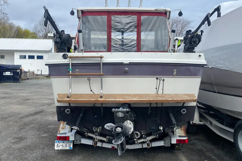 Slide: The Image of 1991 Penn Yan 215 Tempest boat, rear view, parked on a trailer in a lot. - 1