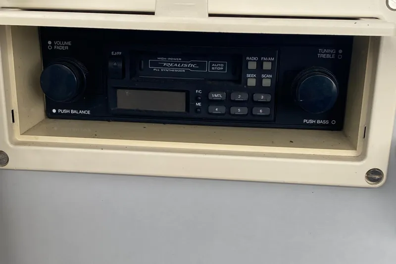 Slide: The Image of 1991 Penn Yan 215 Tempest boat stereo system with cassette player and radio controls. - 10