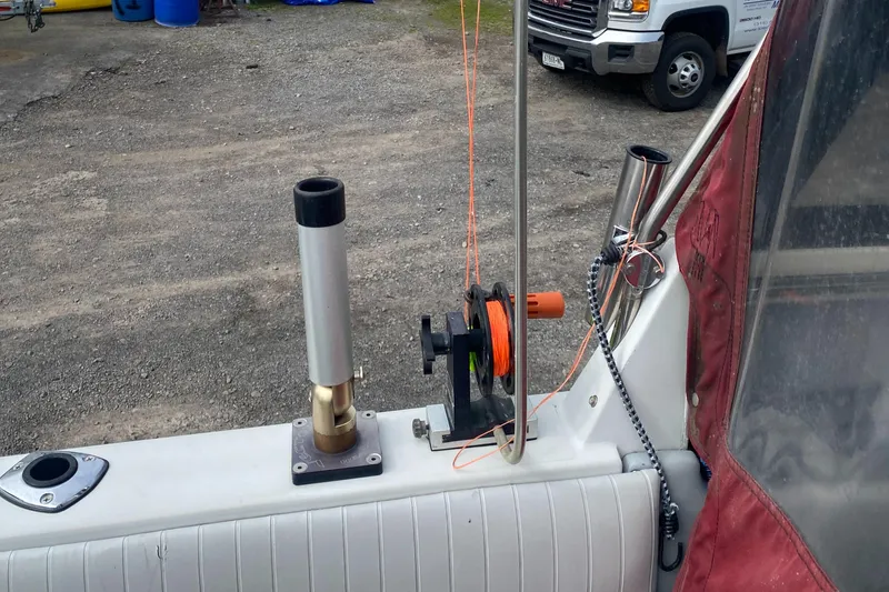 Slide: The Image of 1991 Penn Yan 215 Tempest boat interior with fishing rod holders and equipment. - 12