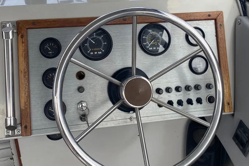 Slide: The Image of Steering wheel and dashboard of 1991 Penn Yan 215 Tempest boat with gauges and controls. - 13