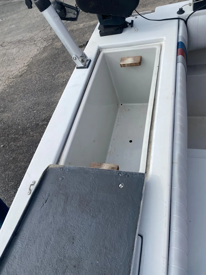 Slide: The Image of 1991 Penn Yan 215 Tempest boat storage compartment with open lid, showing interior space. - 3