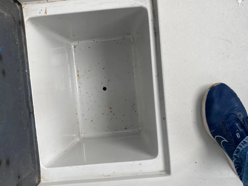 Slide: The Image of Open storage compartment on 1991 Penn Yan 215 Tempest boat deck with foot for scale. - 4