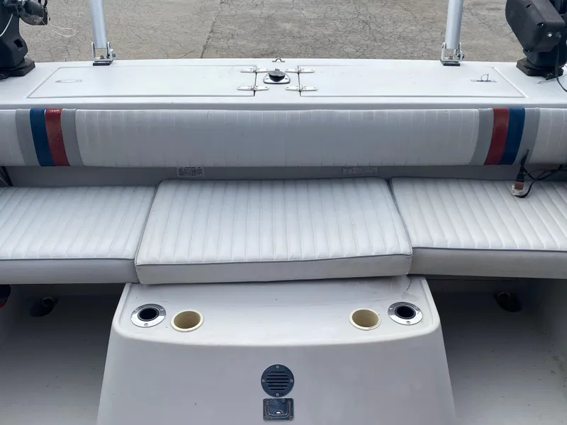 Slide: The Image of 1991 Penn Yan 215 Tempest boat interior with white cushioned seating and cup holders. - 5