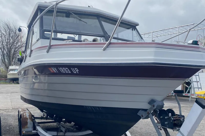 Slide: The Image of 1991 Penn Yan 215 Tempest boat on trailer, parked outdoors, overcast sky. - 6